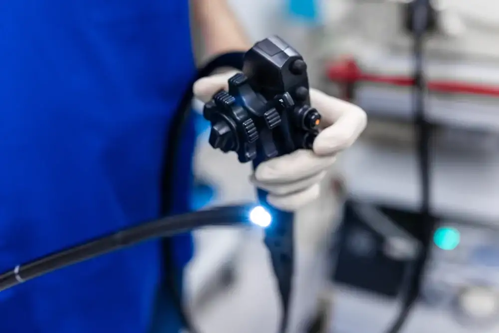 Doctor performing a colonoscopy procedure using a flexible endoscope.